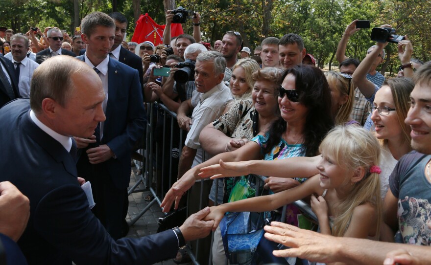Russian President Vladimir Putin greets well-wishers on a visit to Crimea in August 2015. Russia seized and annexed the territory from Ukraine in March 2014.