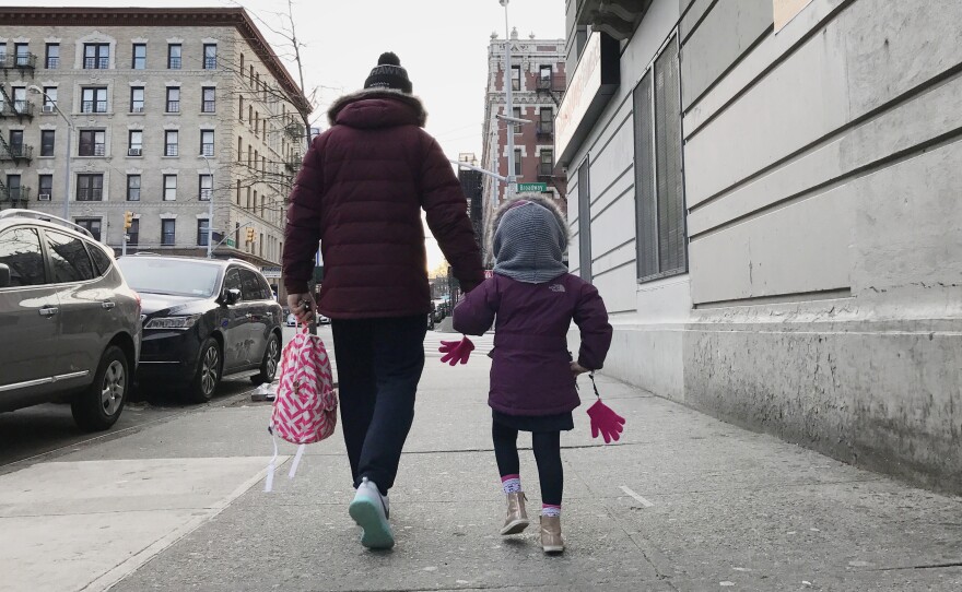 Eduardo walks with his daughter in New York City.