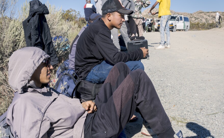 Migrants wait in the desert near Jacumba Hot Springs for immigration processing, October 6, 2023.