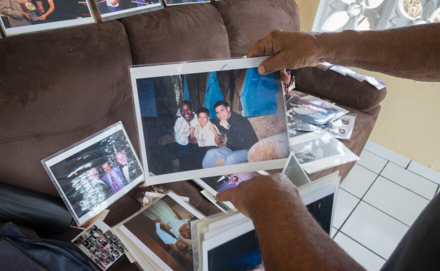 Jose Torres's rearranges some of the photos he was able to save in his home.