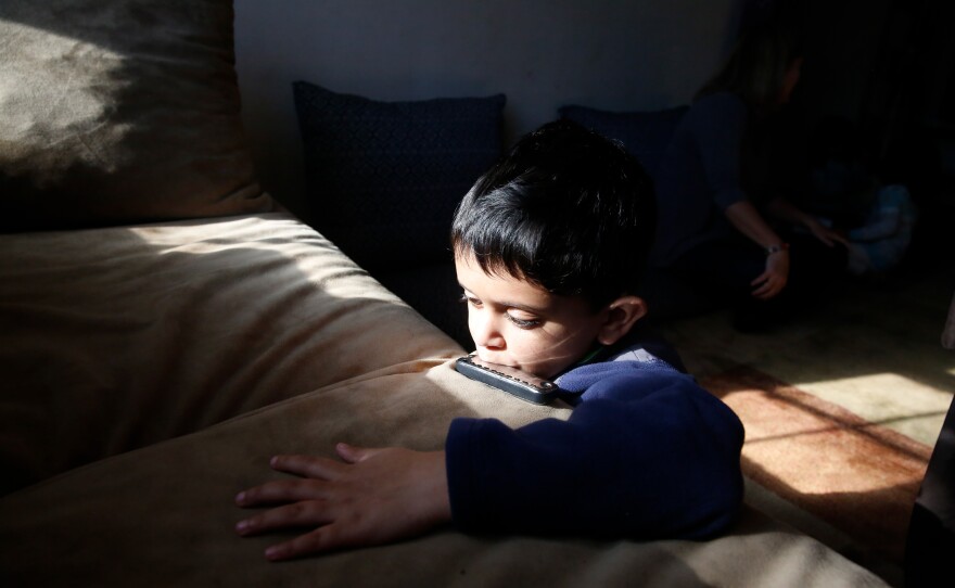 Ezatullah, 8, loves school, where he is working on learning English and Braille in addition to his native language, Pashto. Here, he plays his new harmonica.