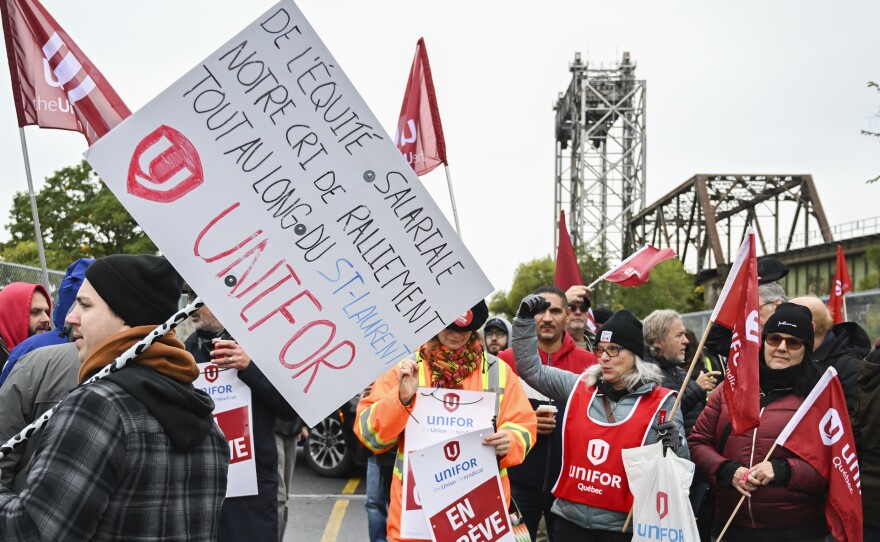 Striking St. Lawrence Seaway workers picket outside the St. Lambert Lock in St. Lambert, Quebec, Monday, Oct. 23, 2023.
