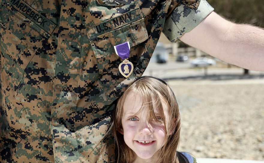 Hardebeck stands with his daughter Adalie and his Purple Heart after the award ceremony. There have been more than 1.8 million Purple Heart recipients since its inception, but Hardebeck believes the number for those who qualify for the award is higher.