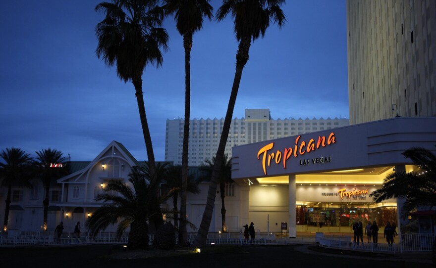 People walk outside of the Tropicana hotel-casino March 28 in Las Vegas. The property closed on Tuesday.
