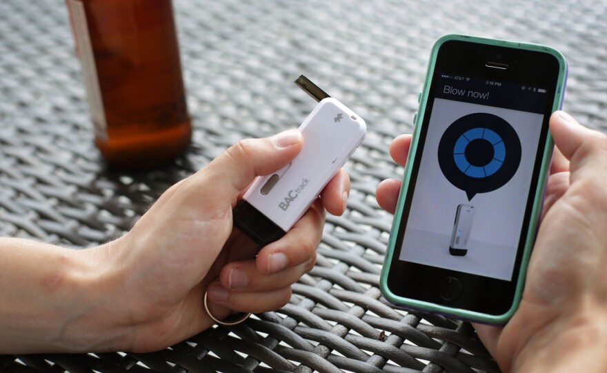 The BACTrack Vio keychain breathalyzer and app on the iPhone at NPR headquarters in Washington, D.C. A public health researcher says tools like this could help people make better decisions about alcohol use.