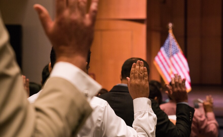 Newly sworn-in U.S. citizens gather for a naturalization ceremony at the Rachel M. Schlesinger Concert Hall and Arts Center in Alexandria, Va., in August. The Trump administration is planning to include a question about U.S. citizenship status on the 2020 census.