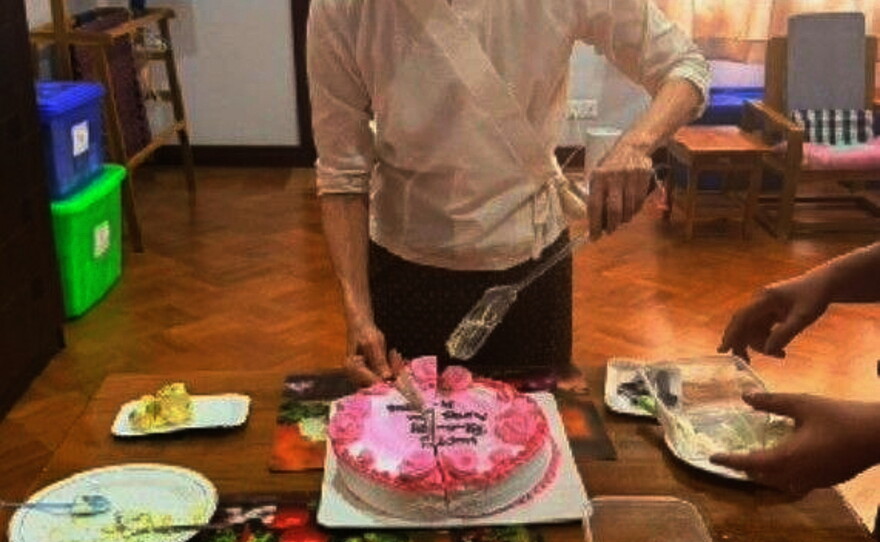 In this photo released by Myanmar President Office on Monday, Aug. 3, 2026, Myanmar ousted leader Aung San Suu Kyi cuts a birthday cake during her meeting with Arnaud de Baecque, resident representative of the International Committee of the Red Cross, in Naypyitaw, Myanmar.