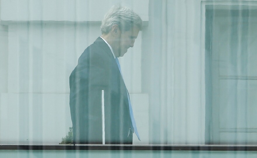 Secretary of State John Kerry walks on the terrace of Palais Coburg, the venue for nuclear talks in Vienna, Austria, on Sunday.