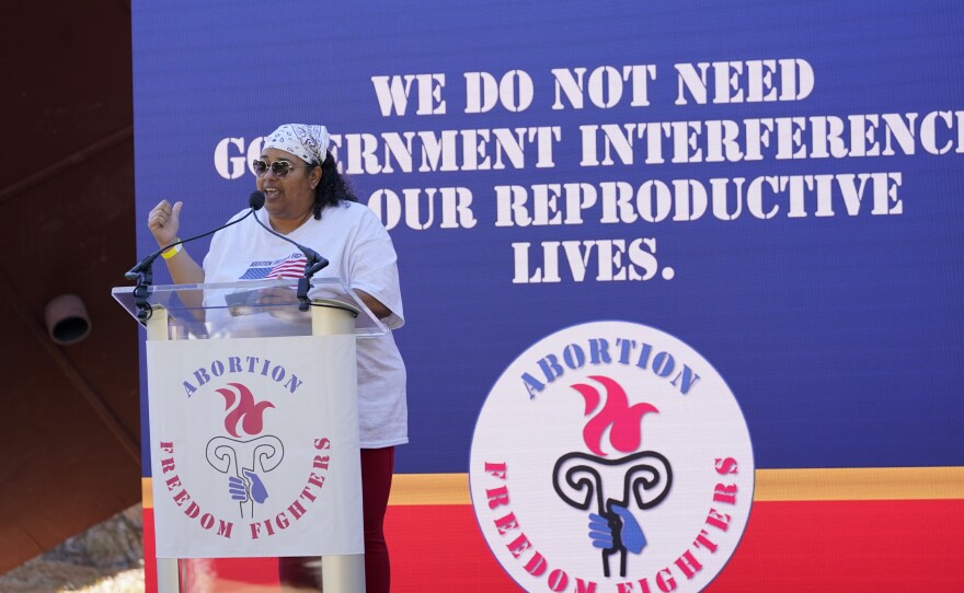 Michelle Colon, co-founder and executive director of SHERO, reminds the audience that the government "need not interfere in the reproductive lives of women," during an abortion rights rally in Smith Park in Jackson, Miss., Wednesday, Dec. 1, 2021.