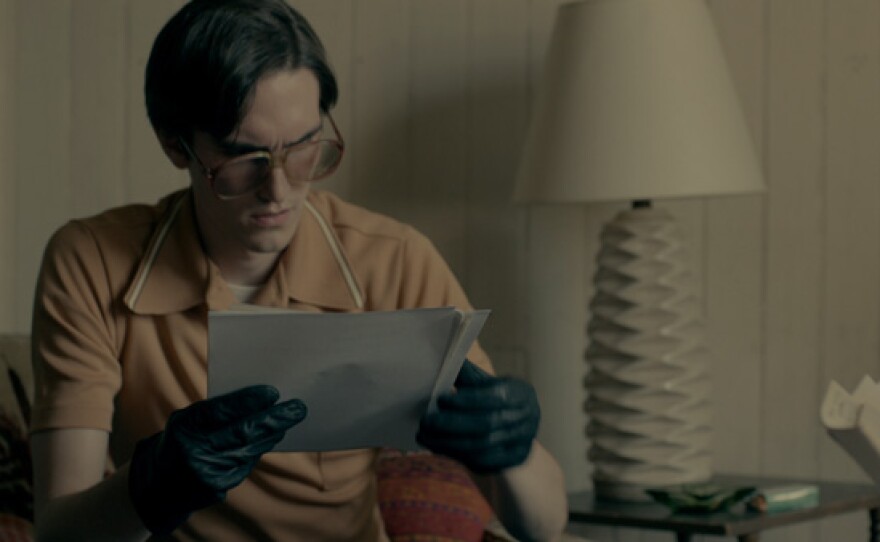 Keith Forsyth (played by Daniel S. Taylor) reads a stolen document.