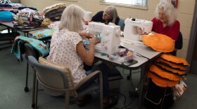Group of volunteers with Kennel Comforters sits at a table with sewing machines on Nov. 1, 2024 in Carlsbad, Calif.