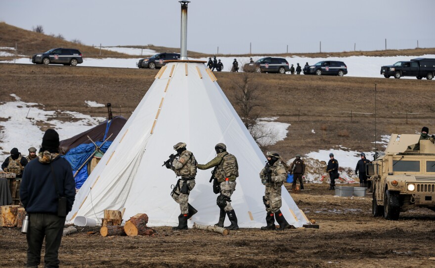 Police check tents one-by-one for remaining protestors.