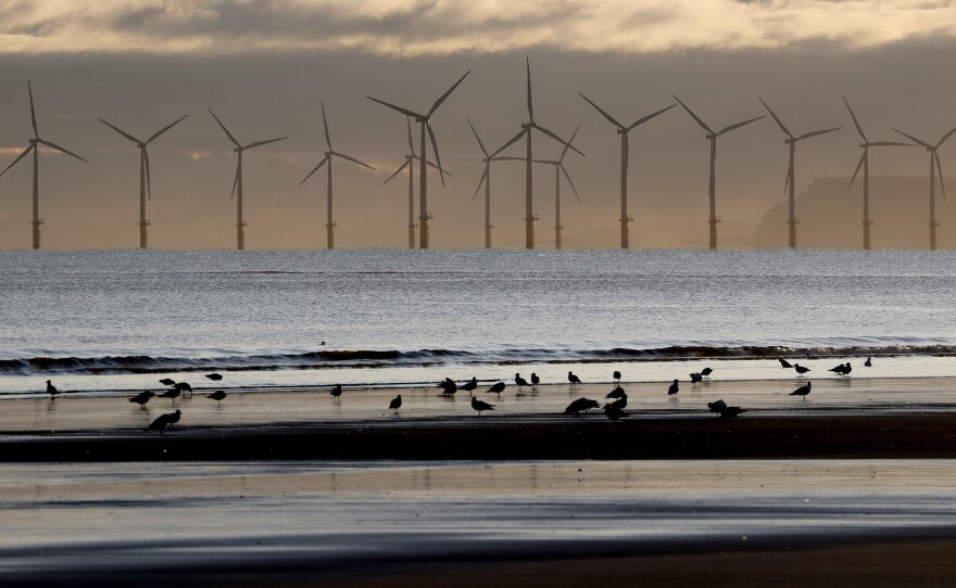 Wind turbines generate electricity off the coast of England. World leaders will meet later this week in Dubai to discuss global efforts to reduce emissions of planet-warming pollution and transition to renewable energy sources.