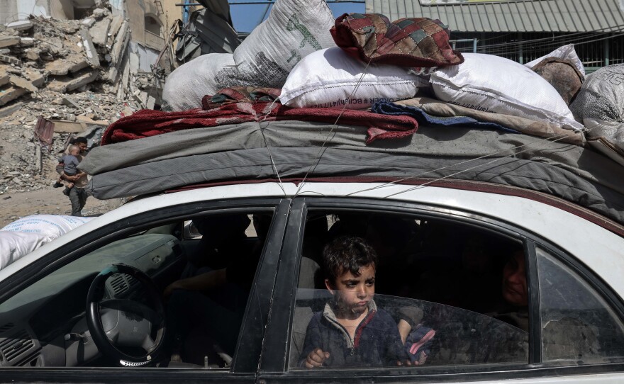 A young boy looks out from a car as members of a Palestinian family leave Rafah in the southern Gaza Strip with personal belongings on March 31.