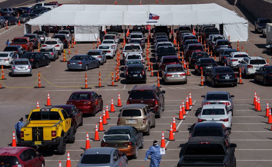 Cars line up Friday at a coronavirus testing site at the University of Texas at El Paso. The area has seen a surge in cases in recent weeks, and a two-week curfew is now in effect in El Paso County.