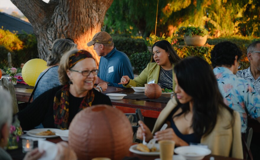 People talk during KPBS' South Bay elections engagement event at Olivewood Gardens and Learning Center in National City, California on October 24, 2024.