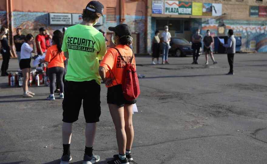 Security Latinos De La Lake volunteers wear bright T-shirts prominently displaying the group's name, in part, to let law enforcement know who they are.