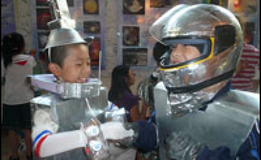 Young space enthusiasts wear homemade astronauts costumes as they wait for China's first-ever space walk.