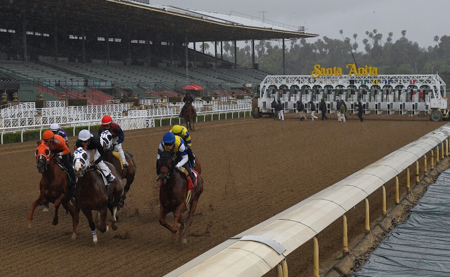 Horses run in the fourth race at Santa Anita Park in front of empty stands in Arcadia, Calif., in 2020.