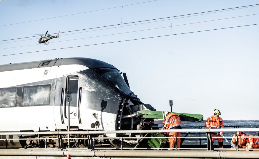 Emergency crews work at the site of a train accident that killed at least six people Wednesday in Nyborg, Denmark. The accident took place on one of the bridges in the Storebaelt system, also known as the Great Belt link.