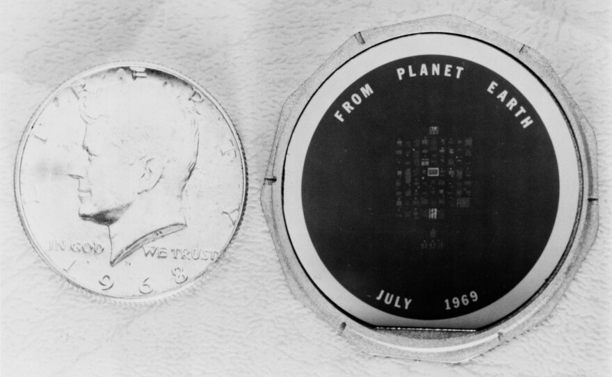 The 1 1/2-inch silicon disk left on the moon by the Apollo 11 astronauts bears messages of goodwill from many heads of state. The process used to make this wafer is the same as that used to manufacture integrated circuits for electronic equipment.