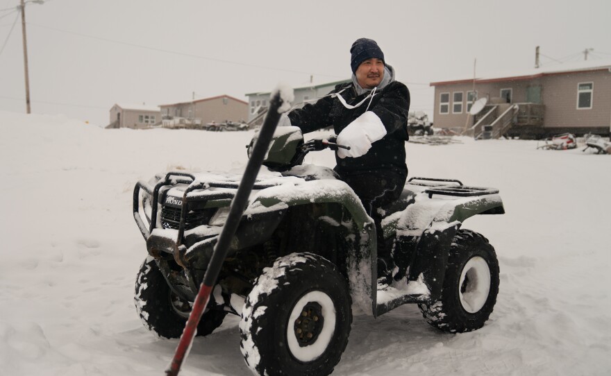 Noah Lincoln, a subsistence hunter and assistant coach for the local high school boys' basketball team, sits on his ATV outside his home in Toksook Bay.