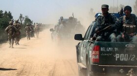 Afghan police and U.S. Marines patrol the city of Marjah in the Helmand province of Afghanistan in April 2010.