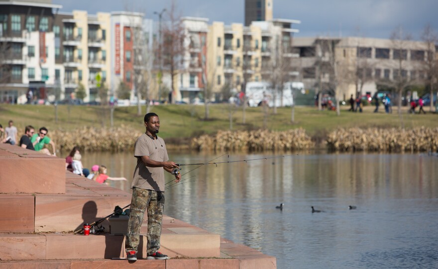 Ervin King fishes for bass and perch in Mueller's Lake Park. Developers decided to keep private yards small in favor of large public parks and green space, creating a destination outdoor space for the surrounding east Austin community.