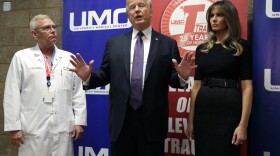 President Donald Trump talks as first lady Melania Trump and surgeon Dr. John Fildes listens at the University Medical Center after Trump met with survivors of the mass shooting Wednesday, Oct. 4, 2017, in Las Vegas.