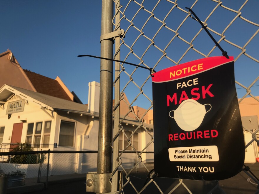 A sign reads "face mask required" in front of the McGill School of Success in the South Park neighborhood of San Diego, Calif. Oct. 13, 2021.