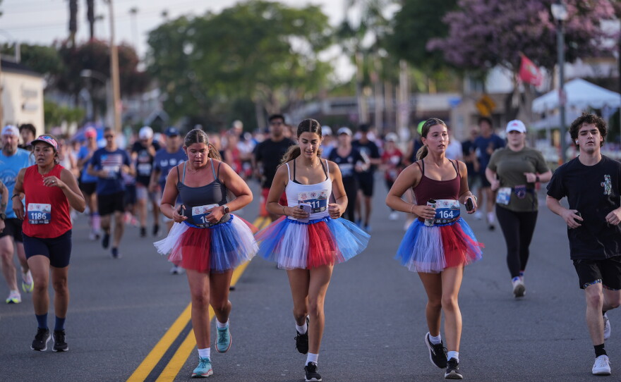 Runners in patriotic-colored tutus participate in a run on Independence Day in Huntington Beach, Calif. on Saturday.