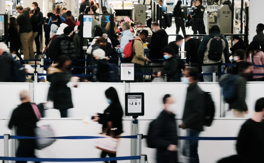 Travelers arrive for flights at Newark Liberty International Airport on November 30.