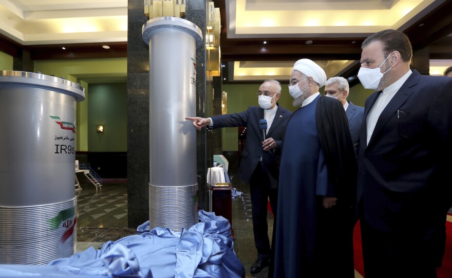 Iranian President Hassan Rouhani (second right) listens to head of the Atomic Energy Organization of Iran Ali Akbar Salehi while visiting an exhibition of Iran's new nuclear achievements in Tehran on Saturday.