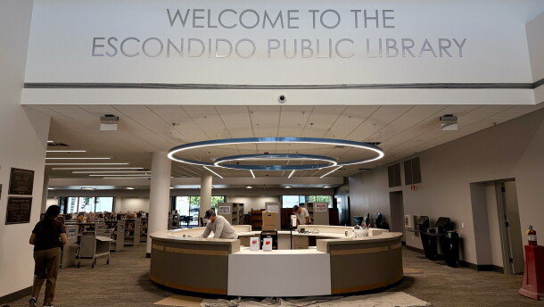 Construction workers finish the welcome desk for the renovated Escondido Public Library, July 14, 2026.