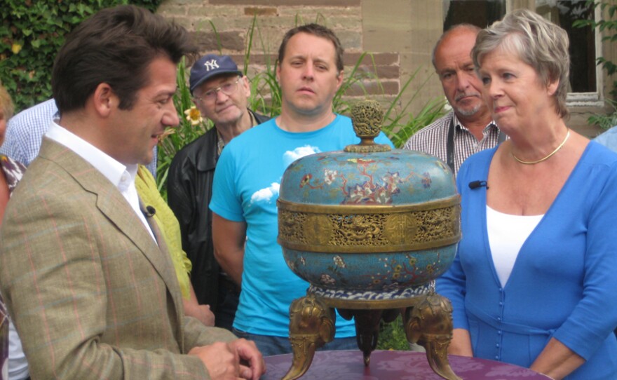 John Axford examines a Chinese Cloisonne incense burner.