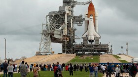 Hundreds of people gather near launch pad 39A to photograph and be photographed with the space shuttle Atlantis one day before its scheduled launch at Kennedy Space Center July 7, 2011 in Cape Canaveral, Florida. 