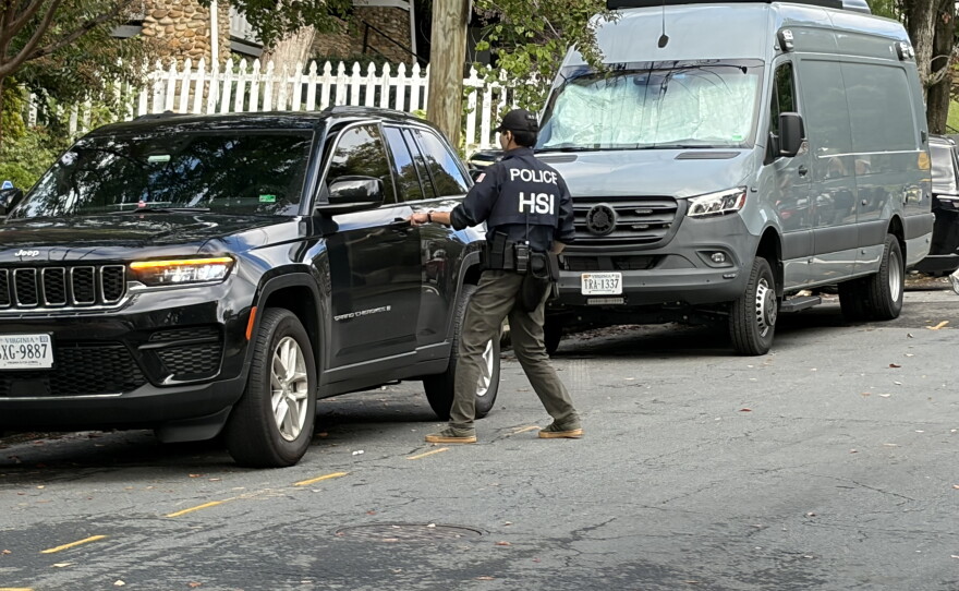 A Homeland Security Investigations agent gets in a car outside the Washington, D.C. residence of Rep. Ilhan Omar, D-Minn., on Monday morning.