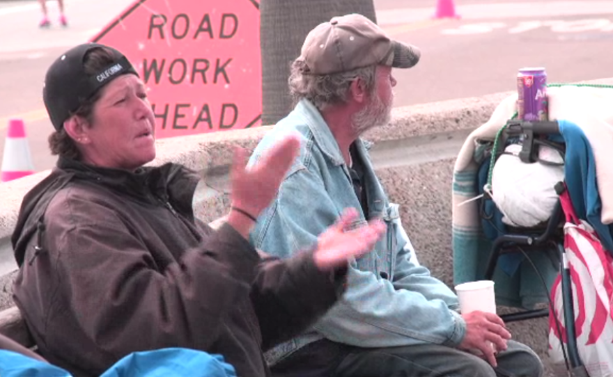 Rebecca Denby sitting with other homeless on a bench near Oceanside pier, April 20, 2017.