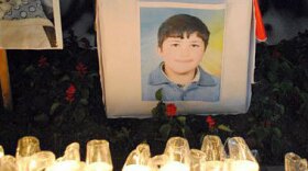 An image of 13-year-old Hamza al-Khateeb is surrounded by candles in this photo from a Facebook page in his memory.
