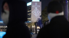 Members of the white nationalist group National Socialist Florida use a laser projector to display white nationalist and anti-LGBTQ images on the side of the CSX building and other high-rise buildings in Jacksonville, Fla.