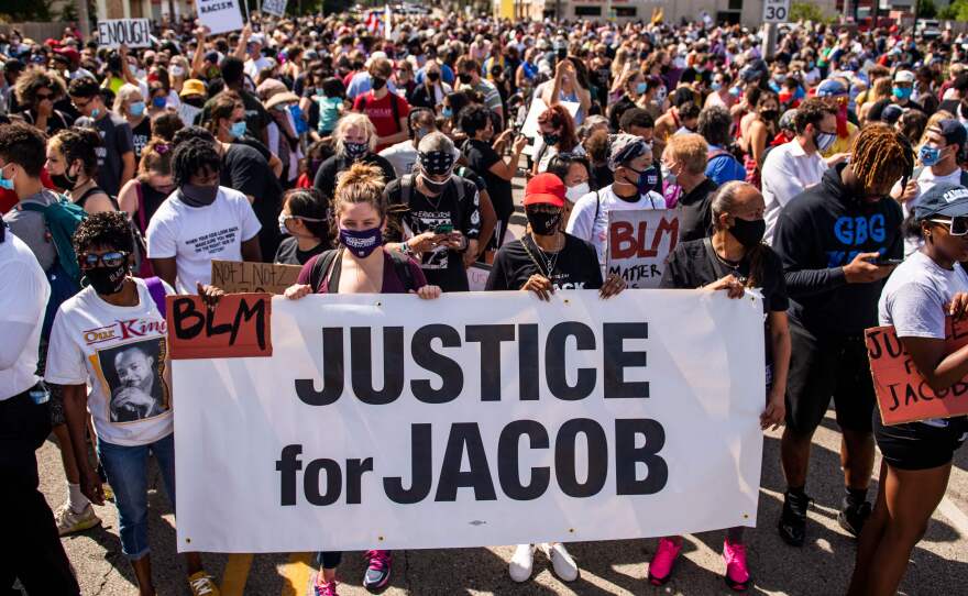 Protesters march with the family of Jacob Blake during a rally against racism and police brutality in Kenosha, Wisconsin, on August 29, 2020.