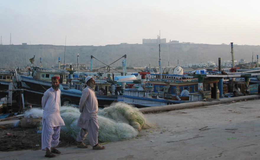 Two men stand near the port in Gwadar, Pakistan. NPR's Phil Reeves unexpectedly ended up a VIP there — and it wasn't a good feeling.