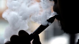 In this April 23, 2014 file photo, a man smokes an electronic cigarette in Chicago.