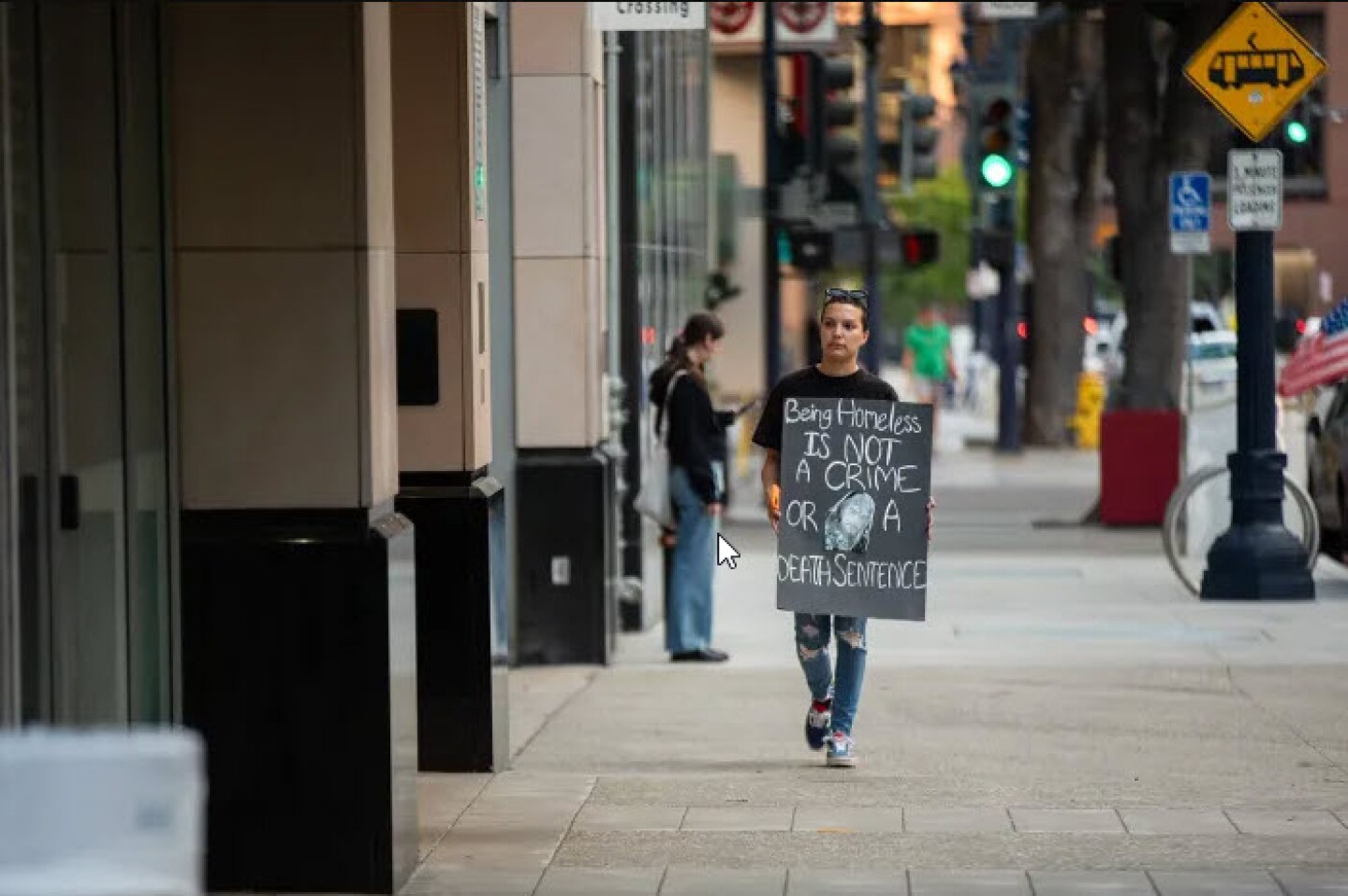 Sabrina Weddle protests in front of the San Diego Central Jail in San Diego on Oct. 24, 2023. Waddle’s brother, Saxon Rodriguez, died while in custody at the jail after overdosing on fentanyl in 2021. 