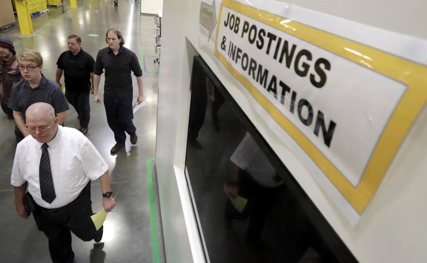 Job candidates take a tour of the Amazon fulfillment center in Robbinsville, N.J., during a job fair in this undated photo. 