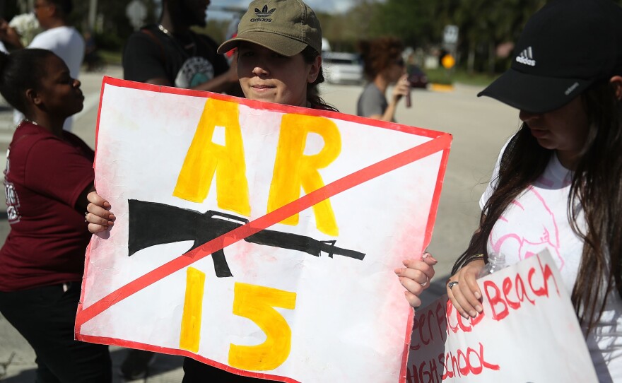 Deerfield Beach high school students arrive at Marjory Stoneman Douglas High School on Friday after walking 11 miles from school to school in support of the victims of the mass shooting in Parkland, Fla.