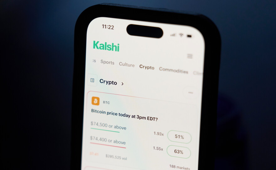 A phone displays crypto trades on Kalshi on Thursday, April 16, 2026, in Portland, Ore.