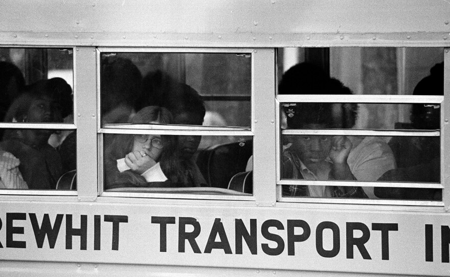 A white student rides the bus together with her black schoolmates to South Boston High School, on Sept. 11, 1975.