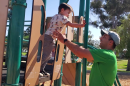 Vince LaPietra helps his son Teddy play on a playground in Balboa Park, Aug. 14, 2022.