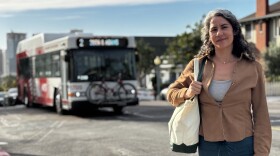 Monica De La Cruz stands in Golden Hill as an MTS bus passes behind her, March 2, 2026.